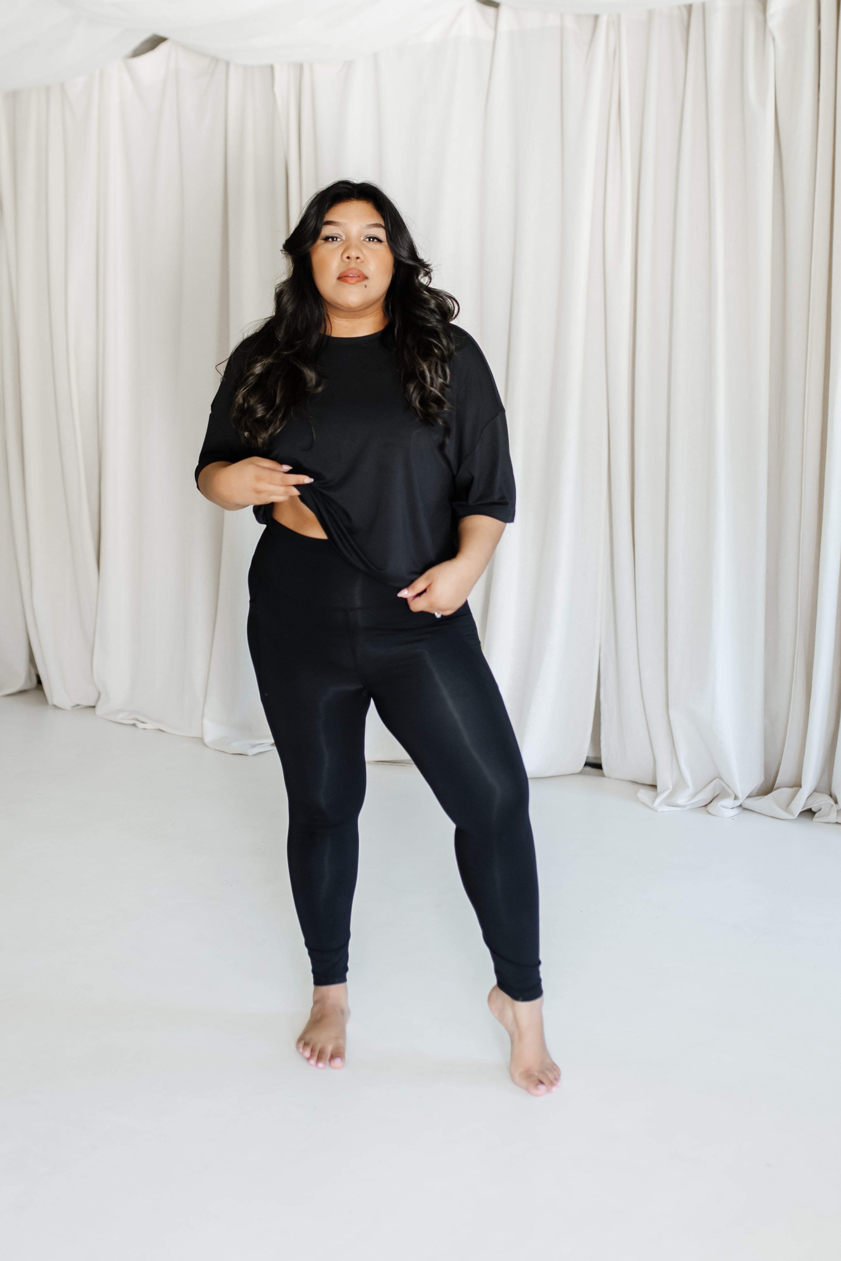 Female model wearing the Bamboo Flex Women’s Leggings in Midnight and matching short sleeve tee