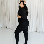 Female model posing wearing the Bamboo Flex Women’s Leggings in Midnight and matching short sleeve tee