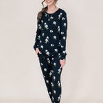 Smiling model wearing the Women's Jogger Set in Midnight Magnolia with hand in pocket