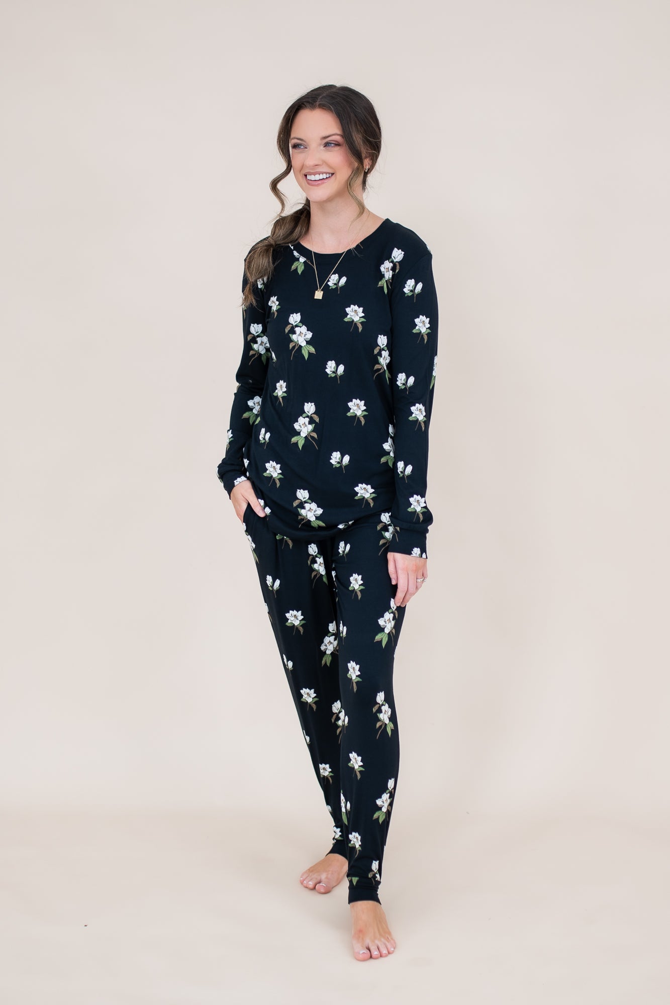 Smiling model wearing the Women's Jogger Set in Midnight Magnolia with hand in pocket