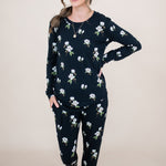 Woman looking to the side with hand on her hip while modeling the Women's Jogger Set in Midnight Magnolia