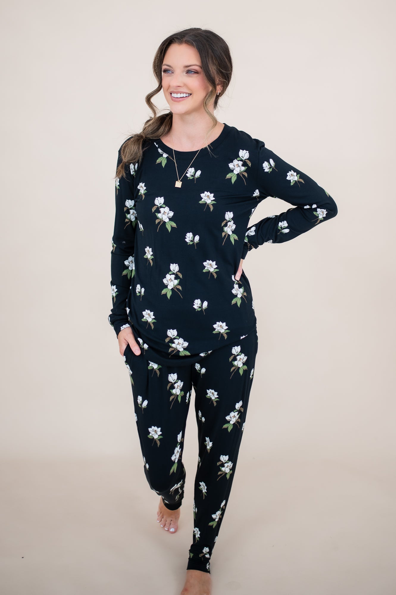 Woman looking to the side with hand on her hip while modeling the Women's Jogger Set in Midnight Magnolia