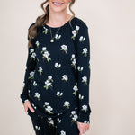 Model smiling at the camera in a close up o the top of the  Kyte Women's Jogger Set in Midnight Magnolia