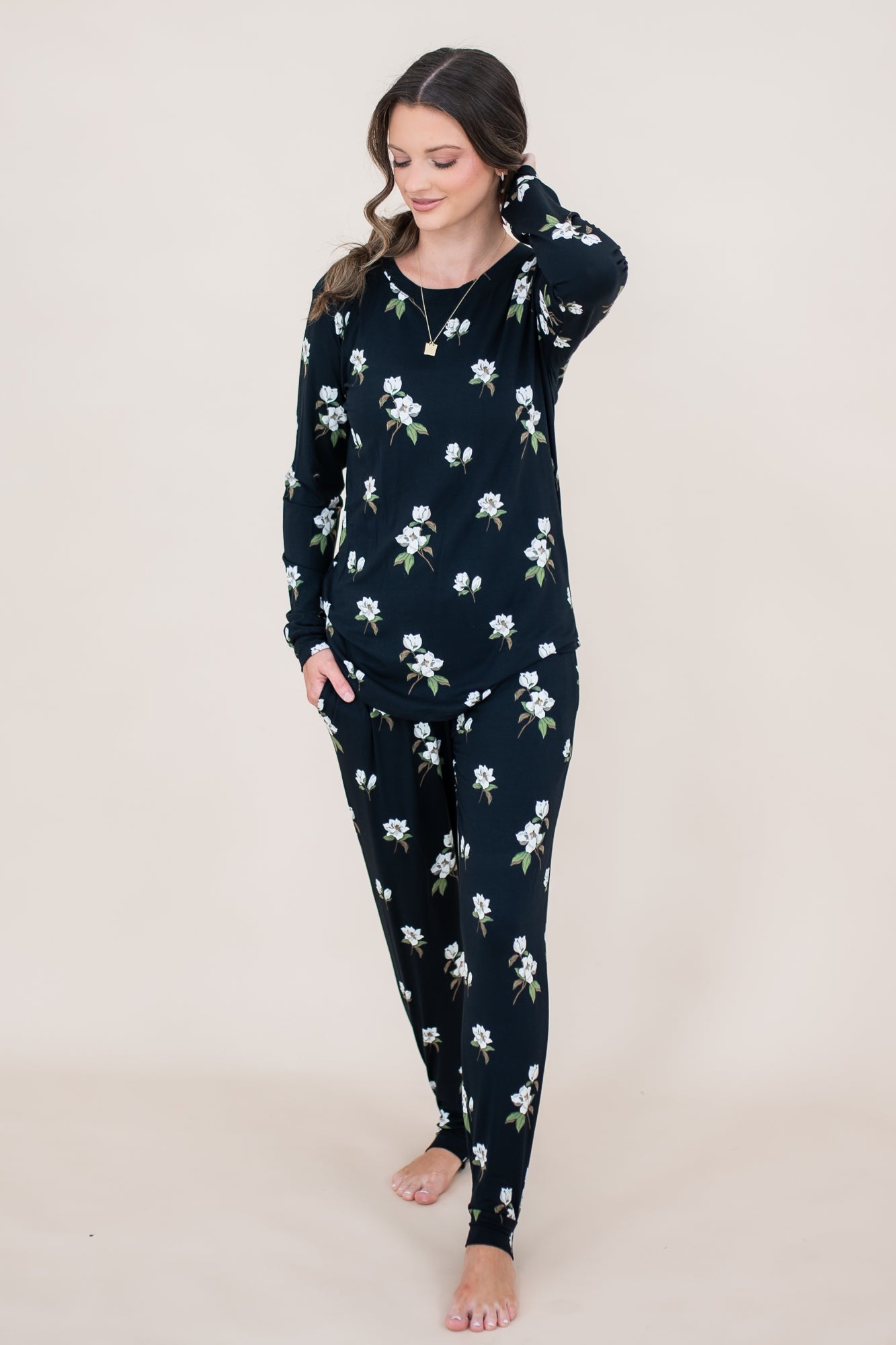 Model with hand in hair while wearing the Kyte  Women's Jogger Set in Midnight Magnolia