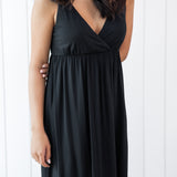 Woman wearing a black nightgown against a white background