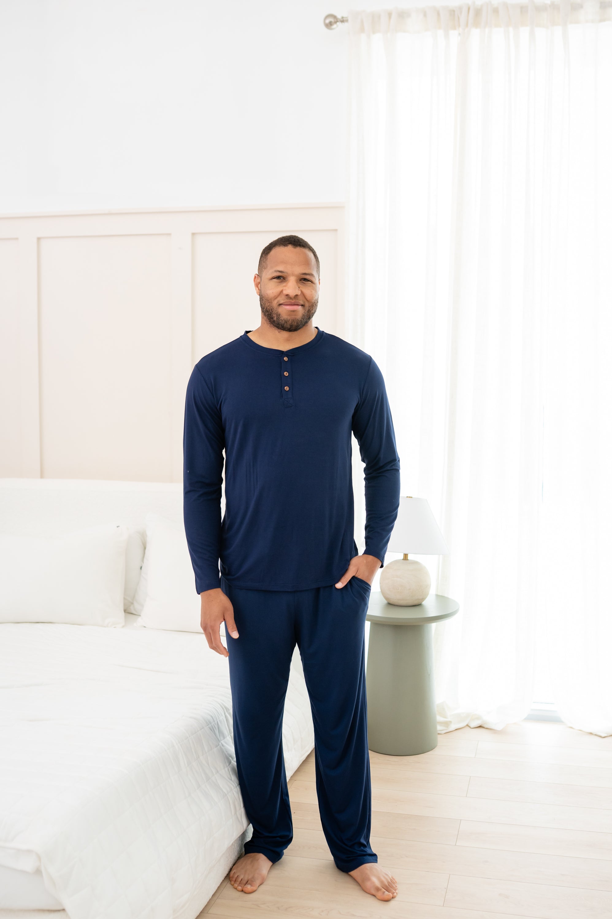 Man modeling Navy Lounge Pant and matching Henley Top