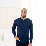 Man modeling Men's Long Sleeve Henley Top in Navy with jeans with hand in pocket