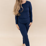 Female model wearing Kyte Baby Women's Jogger Pajama Set in Navy