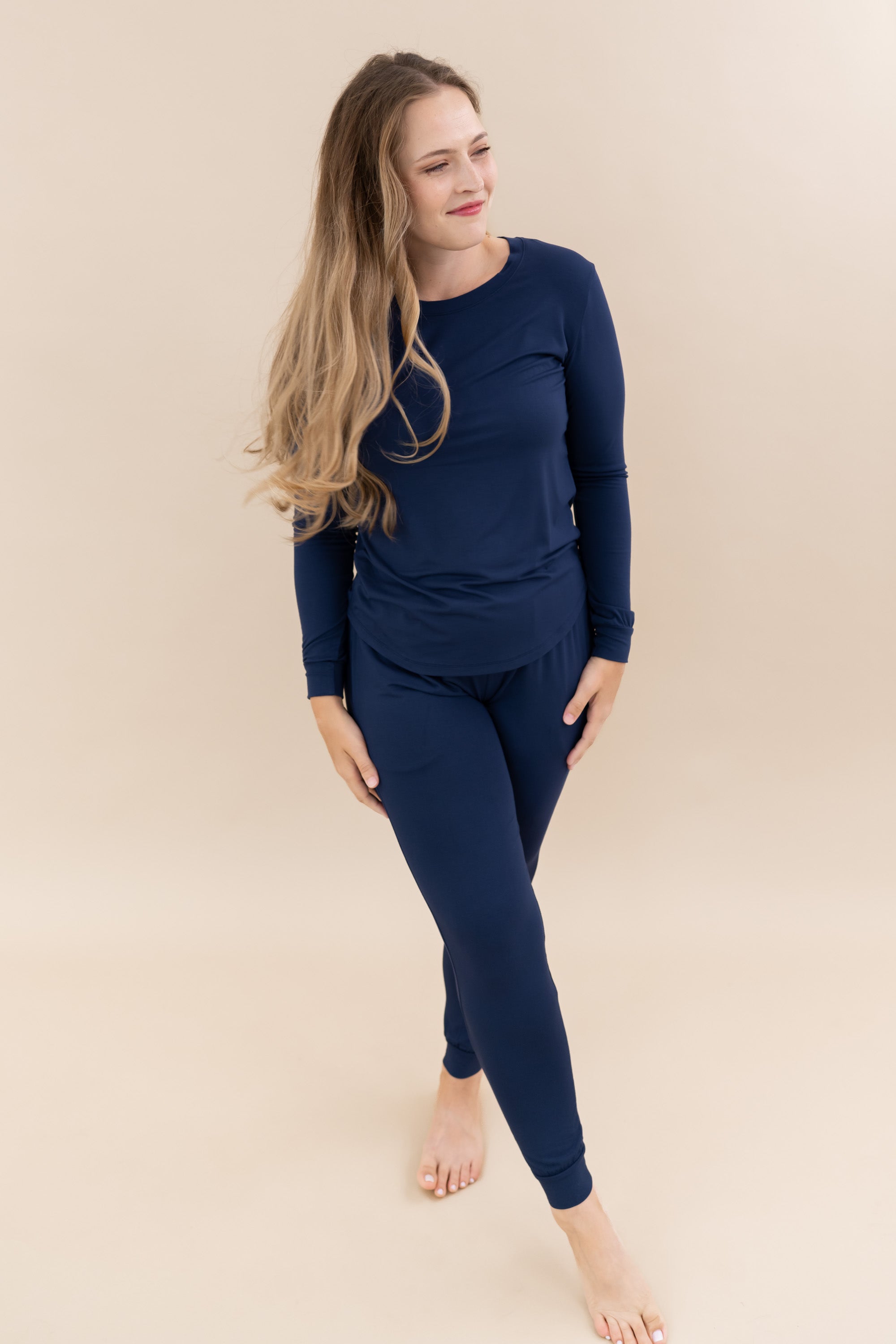 Female model wearing Kyte Baby Women's Jogger Pajama Set in Navy