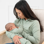 Woman breastfeeding infant while wearing the Women's French Terry Nursing Hoodie in Thyme