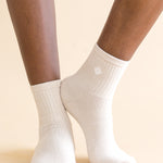 cream socks worn by a person on a beige background