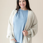 Woman modeling Chunky Knit Women's Oversized Cardigan in Oat and Slate Biker Short Set