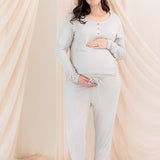 Expectant mother cradling her baby bump wearing the Women's Ribbed Jogger Pant in Oat