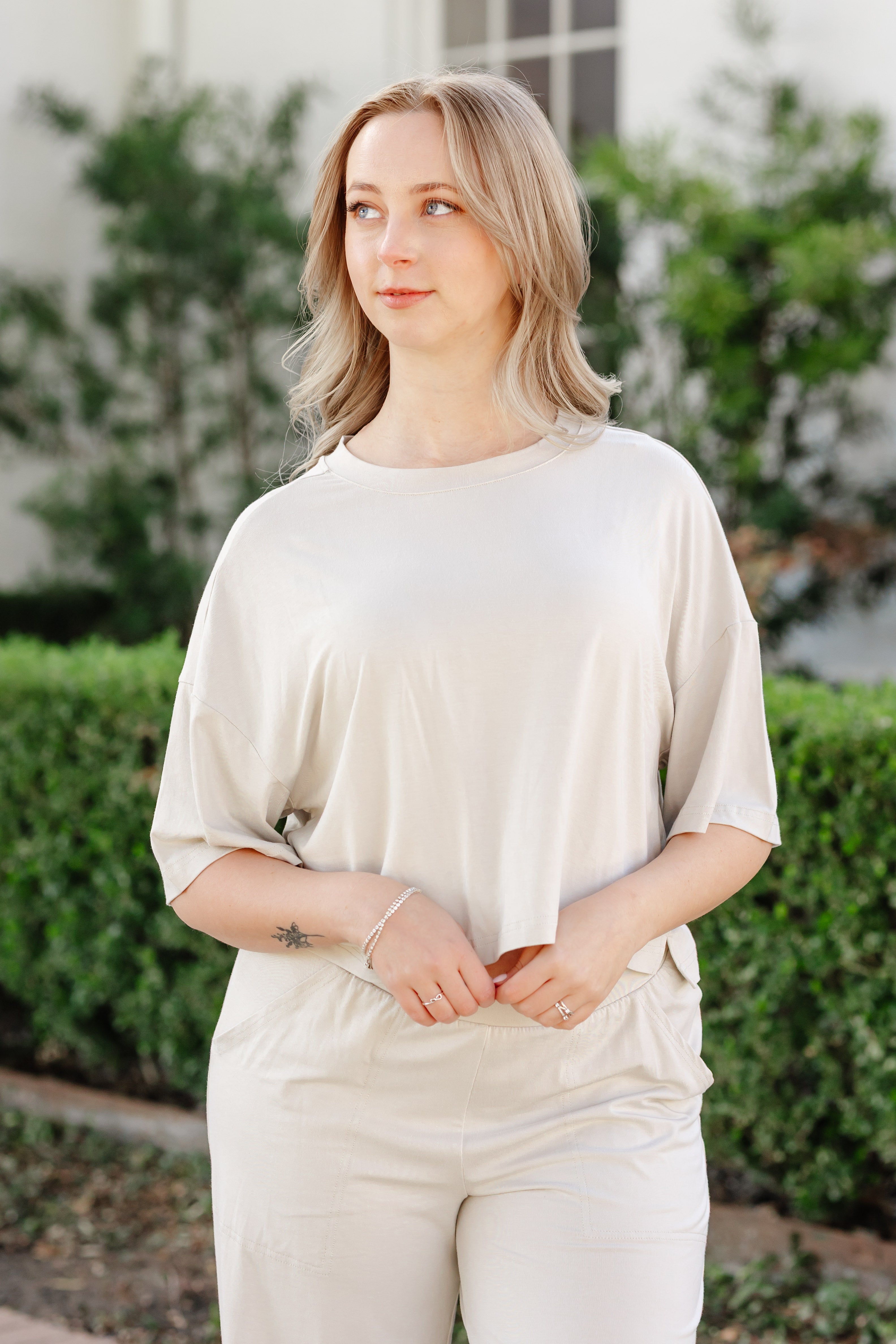 woman modeling an off white tee and matching bottom