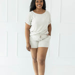 Female wearing the Women's Bamboo Jersey Rollup Sleeve Tee in Oat and Bamboo Jersey Shorts in Oat