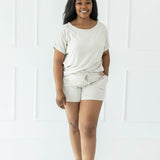 Female wearing the Women's Bamboo Jersey Rollup Sleeve Tee in Oat and Bamboo Jersey Shorts in Oat