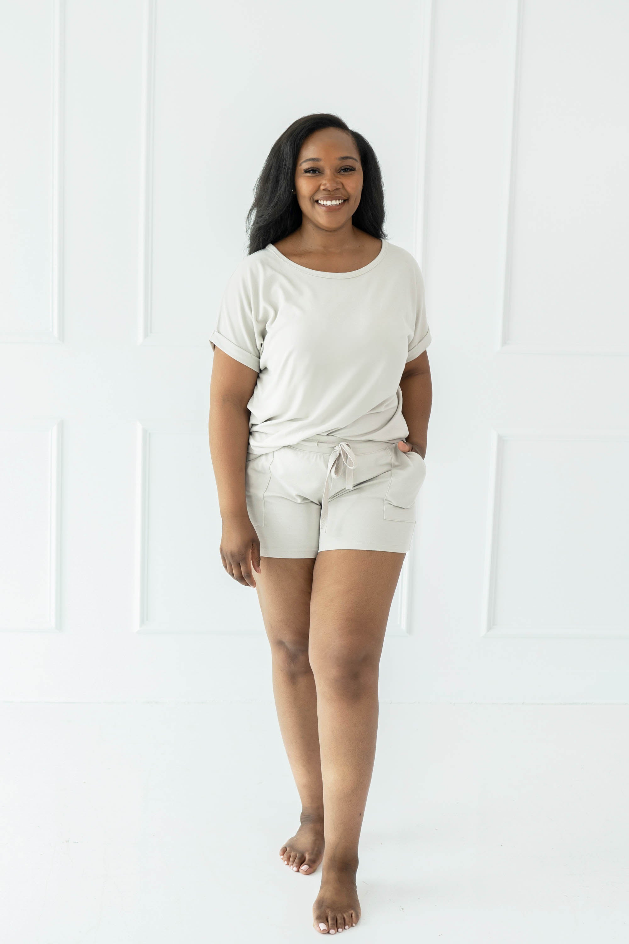 Female wearing the Women's Bamboo Jersey Rollup Sleeve Tee in Oat and Bamboo Jersey Shorts in Oat