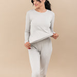 Model stretching the jogger top to show how much elasticity is in the fabric wearing the Women's Jogger Pajama Set in Oat