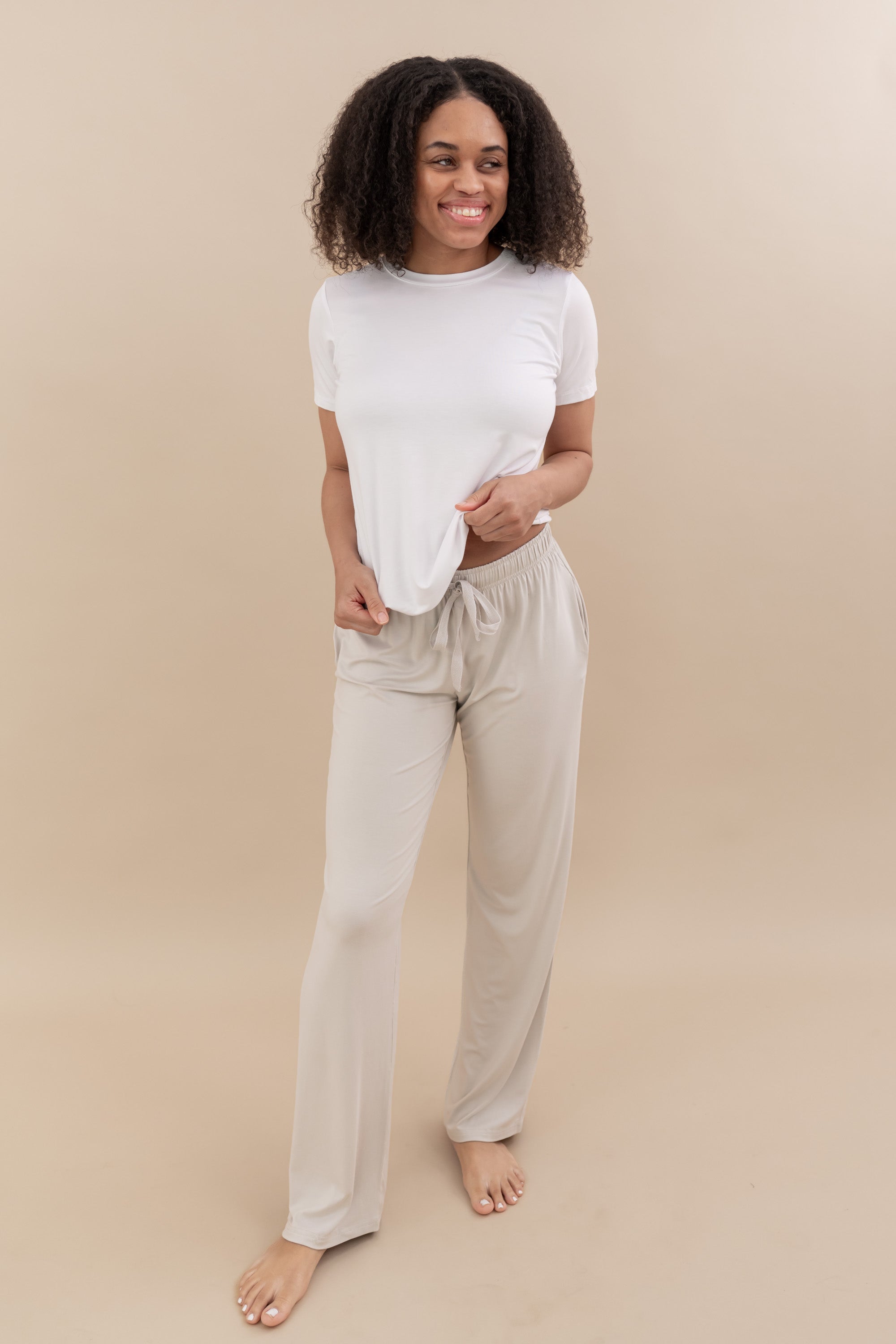 Female wearing the Women's Crew Neck Tee in Snow paired with Kyte Baby's Oat Lounge Pants