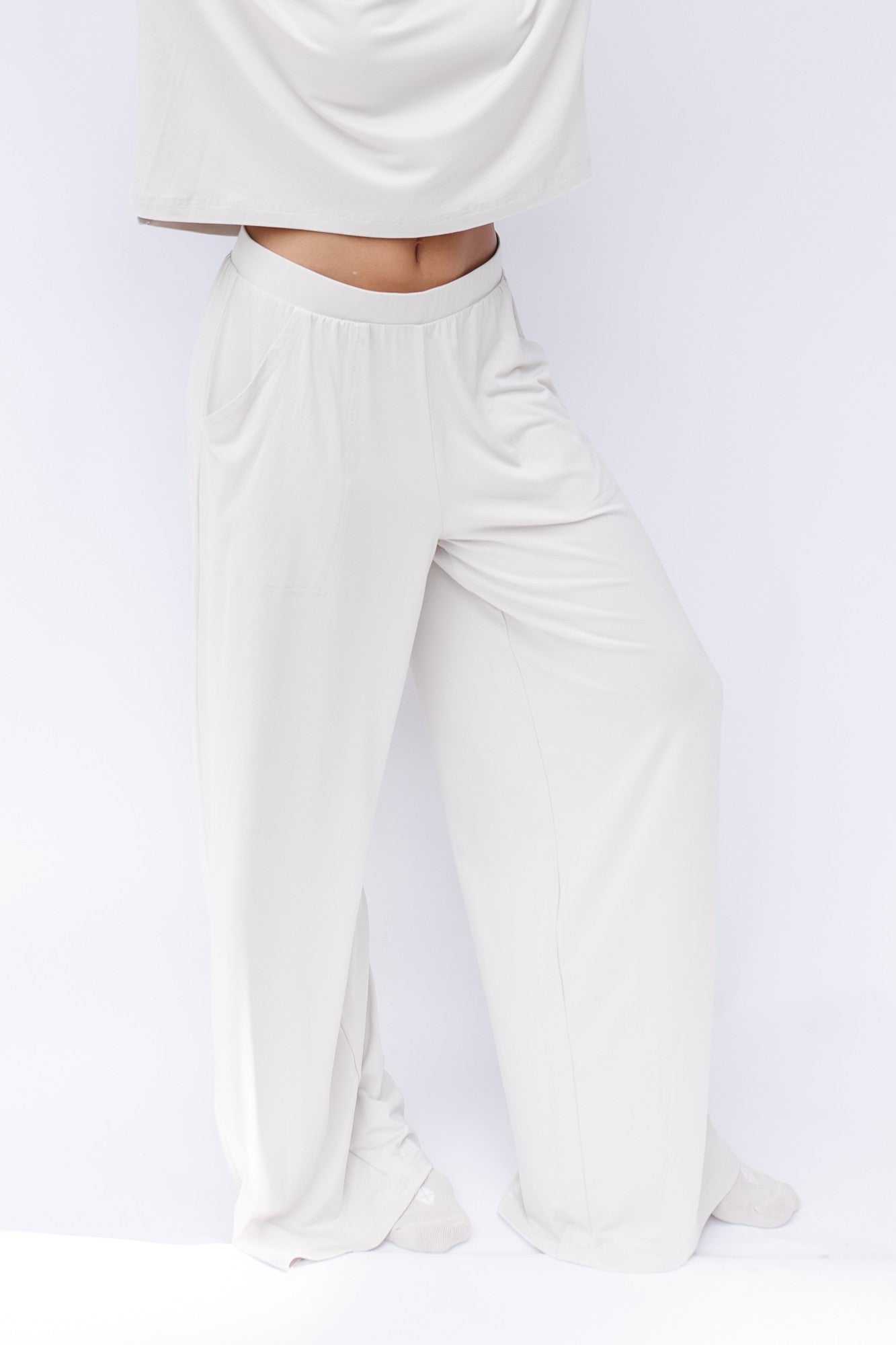 Women's Wide Leg Pant in Oat shown on a model in front of a white backdrop