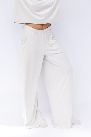 Women's Wide Leg Pant in Oat shown on a model in front of a white backdrop