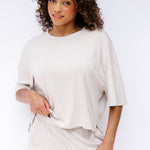 Model wearing the Women's Short Sleeve Tee in Oat and matching wide leg pants