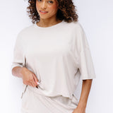 Model wearing the Women's Short Sleeve Tee in Oat and matching wide leg pants