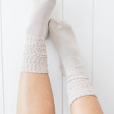 Kyte Scrunch Socks in Oat shown on a model