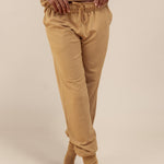 Modal wearing Women's Jogger Pants in Ochre color under similar color women's sweatshirt on a beige background
::: Model is 5'9" wearing size S ///