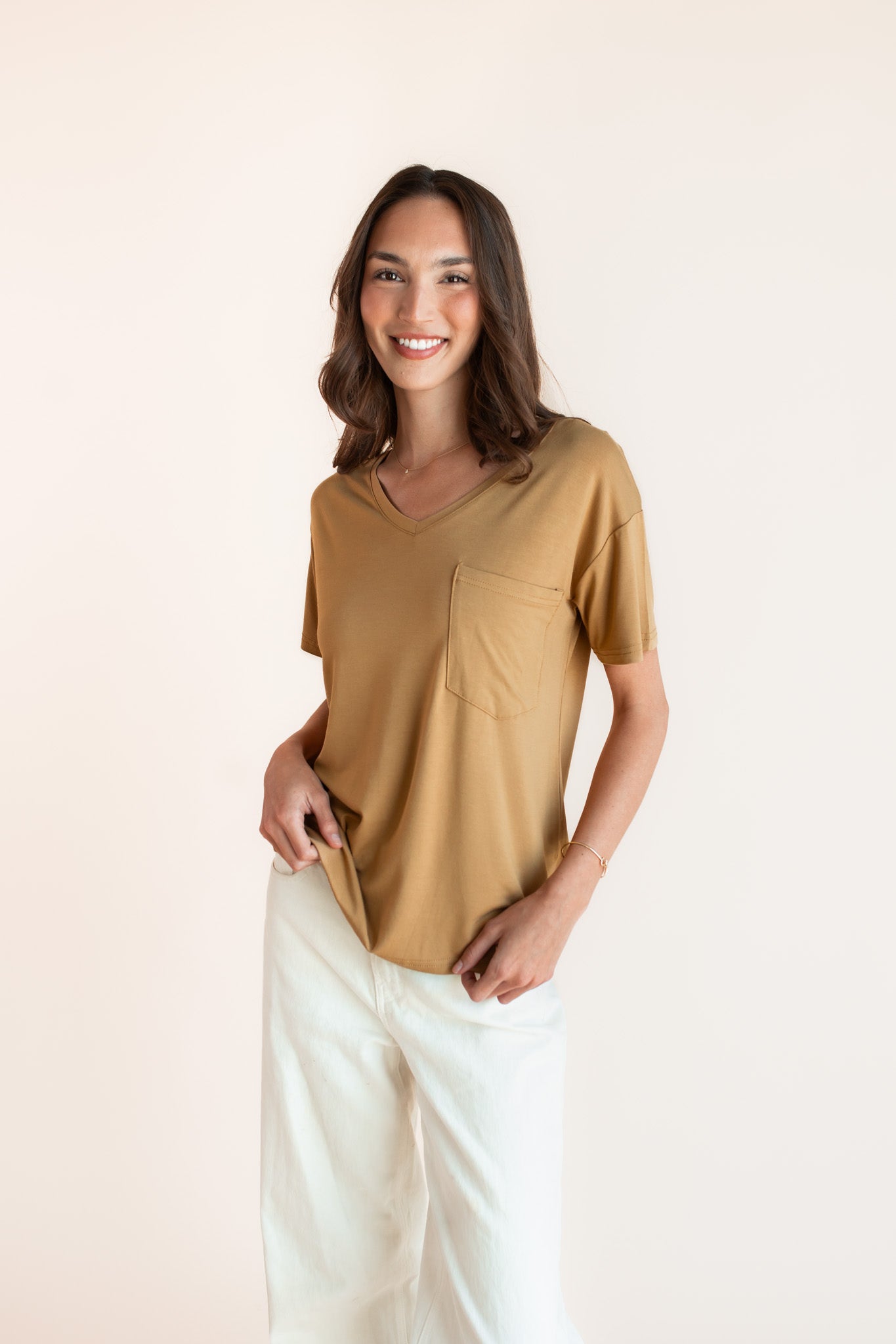 Woman modeling a mustard yellow v-neck oversized tee
::: Model is 5'9.5" wearing size XS ///