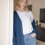Modal posing wearing Chunky Knit Women's Waffle Cardigan in Oxford over white t-shirt and blue jeans