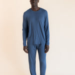 Male model wearing oxford blue jogger set in a studio setting