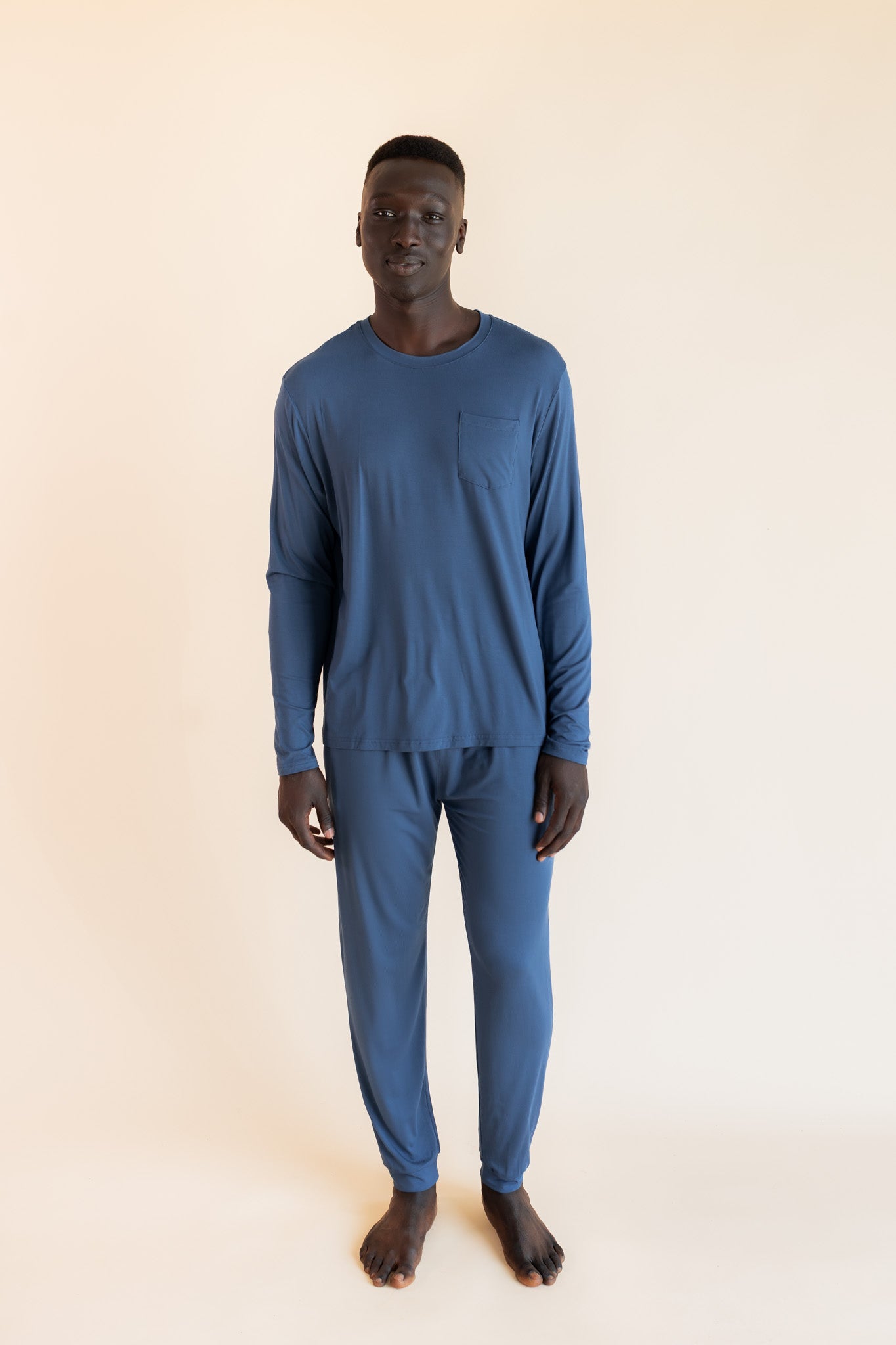 Male model wearing oxford blue jogger set in a studio setting
::: Model is 6'1" wearing size L ///
