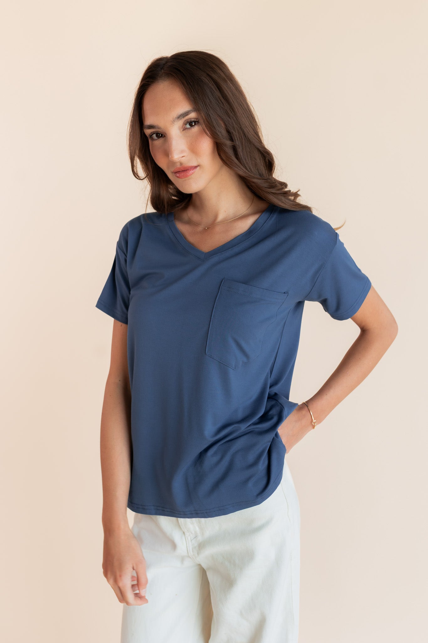 Woman modeling a oxford blue v-neck oversized tee
::: Model is 5'9.5" wearing size XS ///