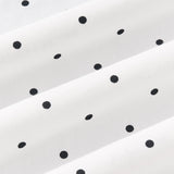 Close up view of Midnight polka dot print on white fabric