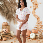 Model in -front o a fall back drop while wearing the Kyte Short Sleeve Pajama Set in Pastel Ghost 