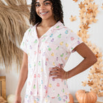 Close up of smiling model in front of Kyte Short Sleeve Pajama Set in Pastel Ghost 