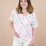 Smiling model with hand on hip wearing the Kyte Women's V-Neck in Pastel Ghost