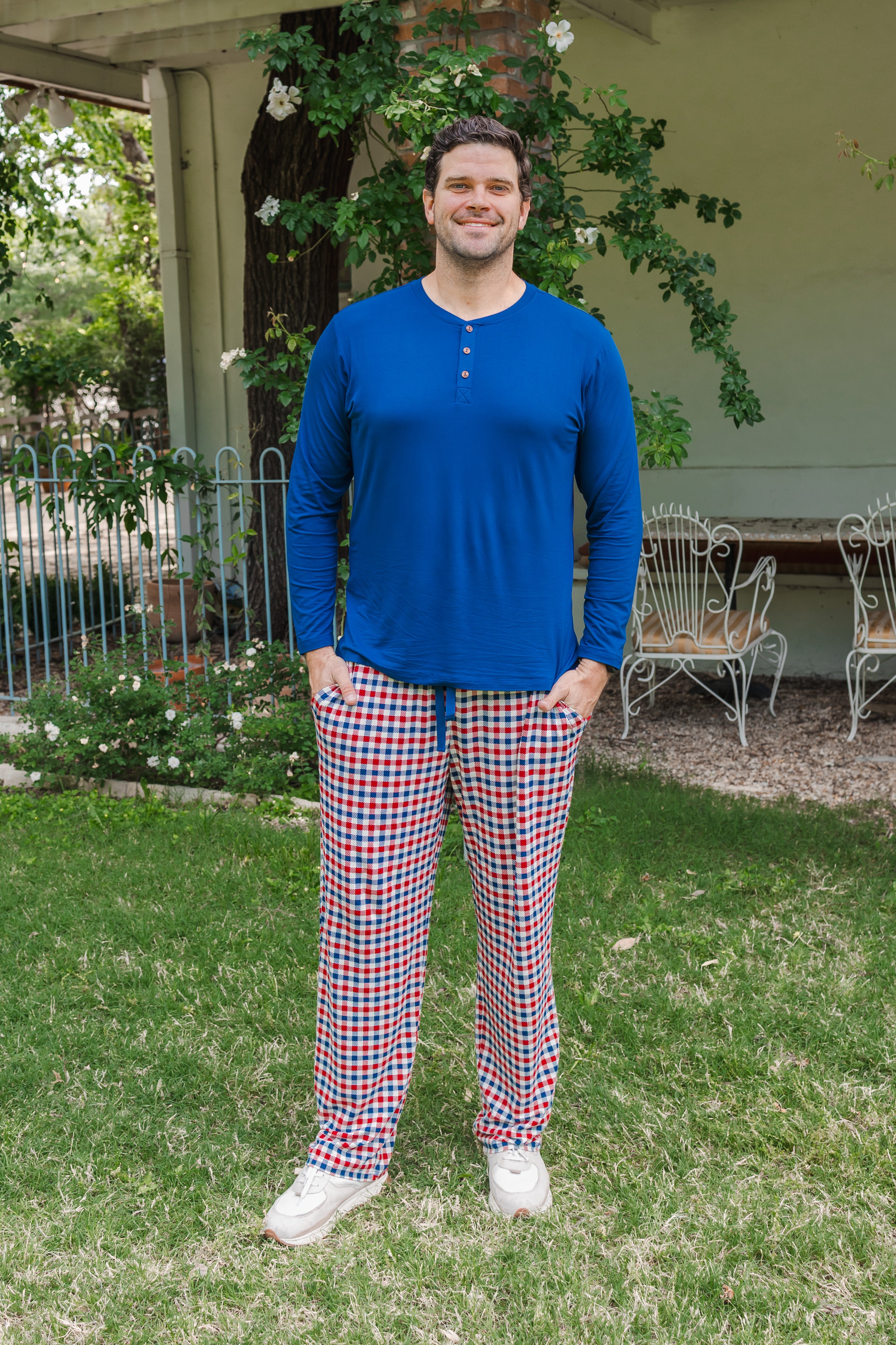 Man wearing Kyte Men's Long Sleeve Henley Top in Tahoe over red white and blue print Men's lounge pant outdoors