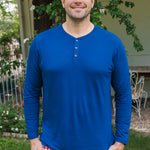Smiling man modeling the Kyte Men's Long Sleeve Henley Top in Tahoe with red white and blue print Men's lounge pant outdoors