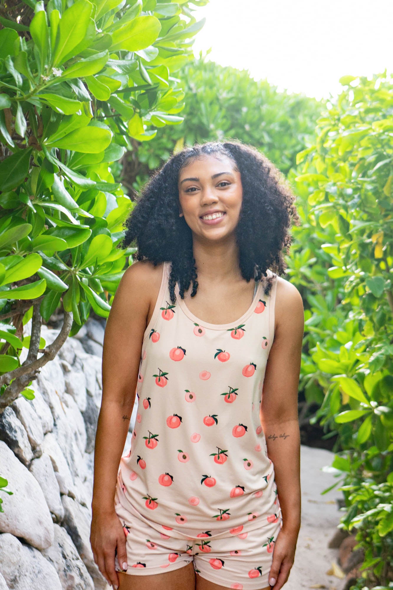 Closer up of a female model wearing the Women’s Tank Set in Peach