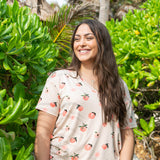 Model wearing the Women’s Relaxed Fit V-Neck in Peach paired with jean shorts