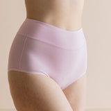 Light pink underwear worn by a person on a beige background