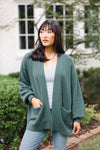 Woman looking to the side with her hand in her cardigan pocked in the color pine
::: Model is 5'9" wearing size S ///