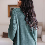 Modal showcasing the backside of Chunky Knit Women's Waffle Cardigan in Pine over blue jeans