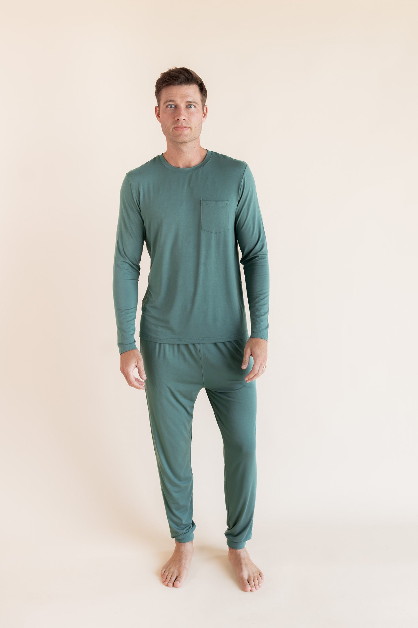 Male model wearing muted sage green jogger set in a studio setting
::: Model is 6'2" wearing size M ///