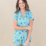 Woman modeling Women’s Short Sleeve Pajama Set in Pineapple. Hand crossed over holding other arm
