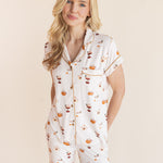Close up of Model wearing Women's Short Sleeve Cropped Pajama Set in Pumpkin Spice Latte print on a beige background
---PJ 2