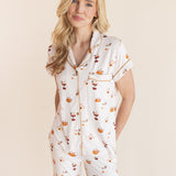 Close up of Model wearing Women's Short Sleeve Cropped Pajama Set in Pumpkin Spice Latte print on a beige background
---PJ 2