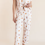 Model showcasing the front side of pajamas of Women's Short Sleeve Cropped Pajama Set in Pumpkin Spice Latte print on a beige background
---1620 3
